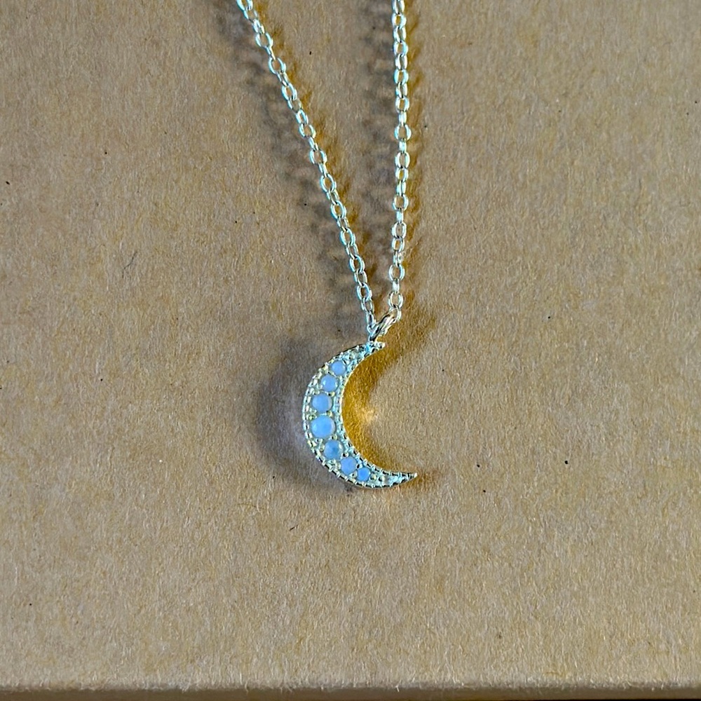 Silver tone crescent moon necklace with crystals